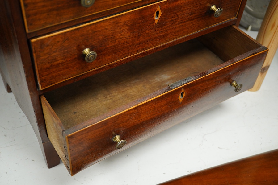 A George III mahogany miniature four drawer chest and key, 40cm high, 35.5cm wide. Condition - good